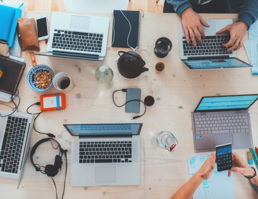 Laptops and people in work environment